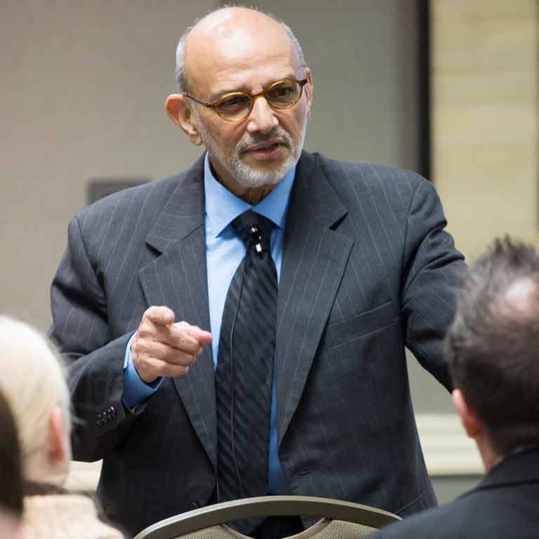 Man in suit makes a point.