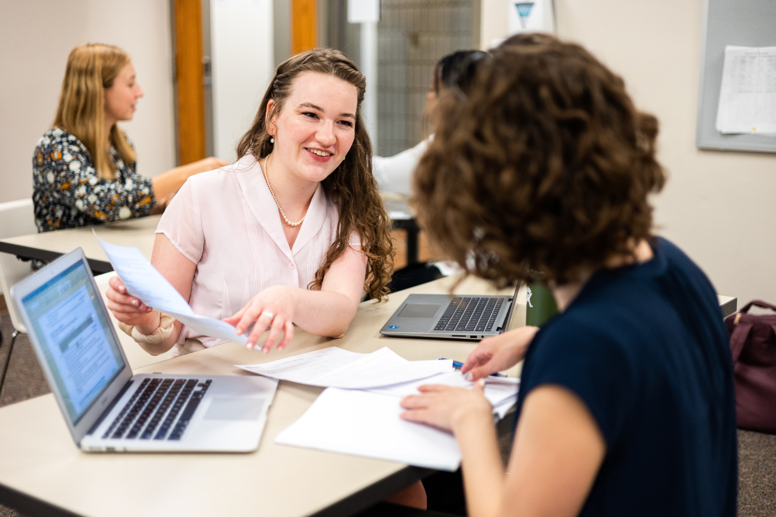 Student and advisor with computer